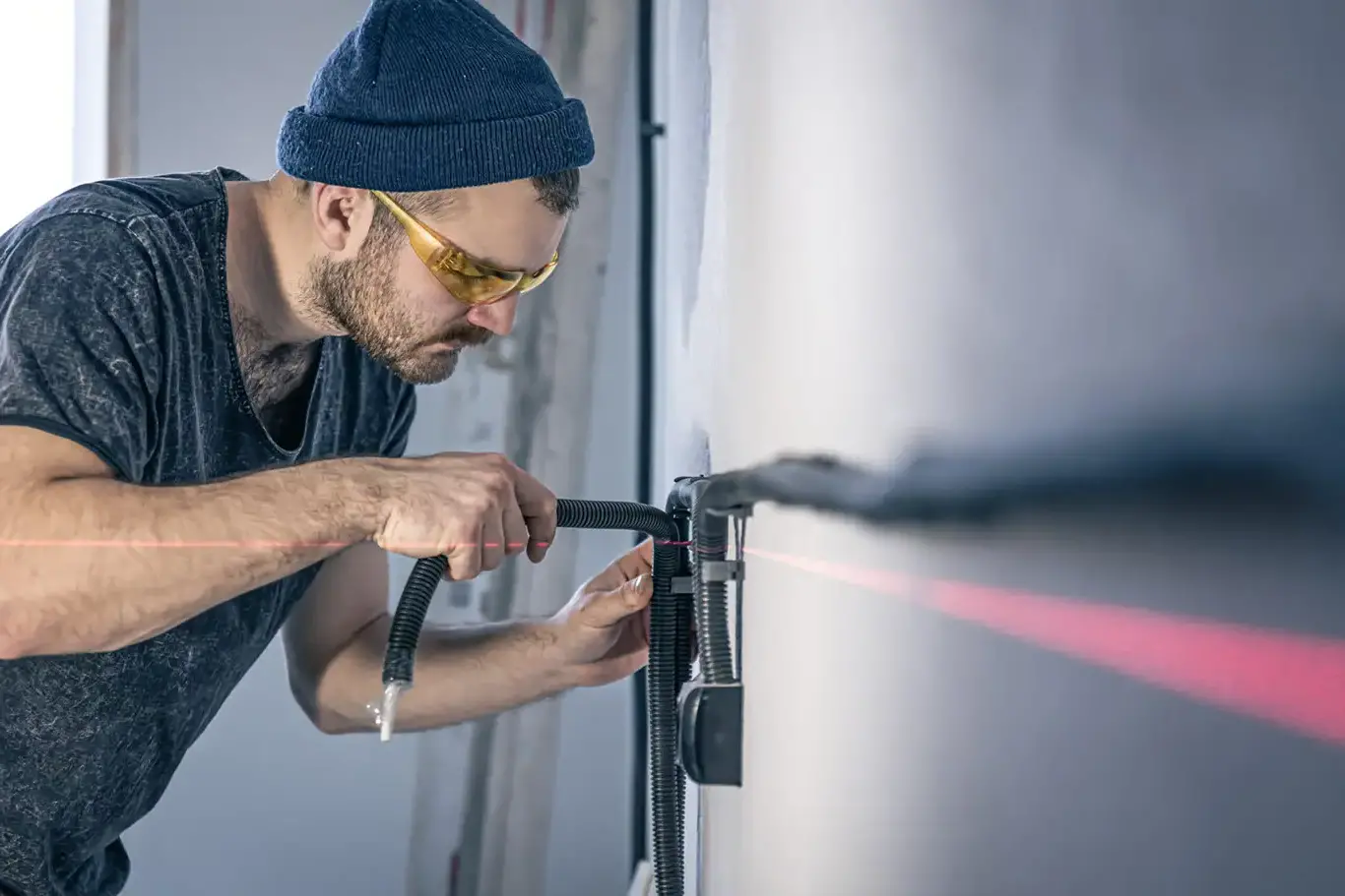 An electrician mounting electrical sockets