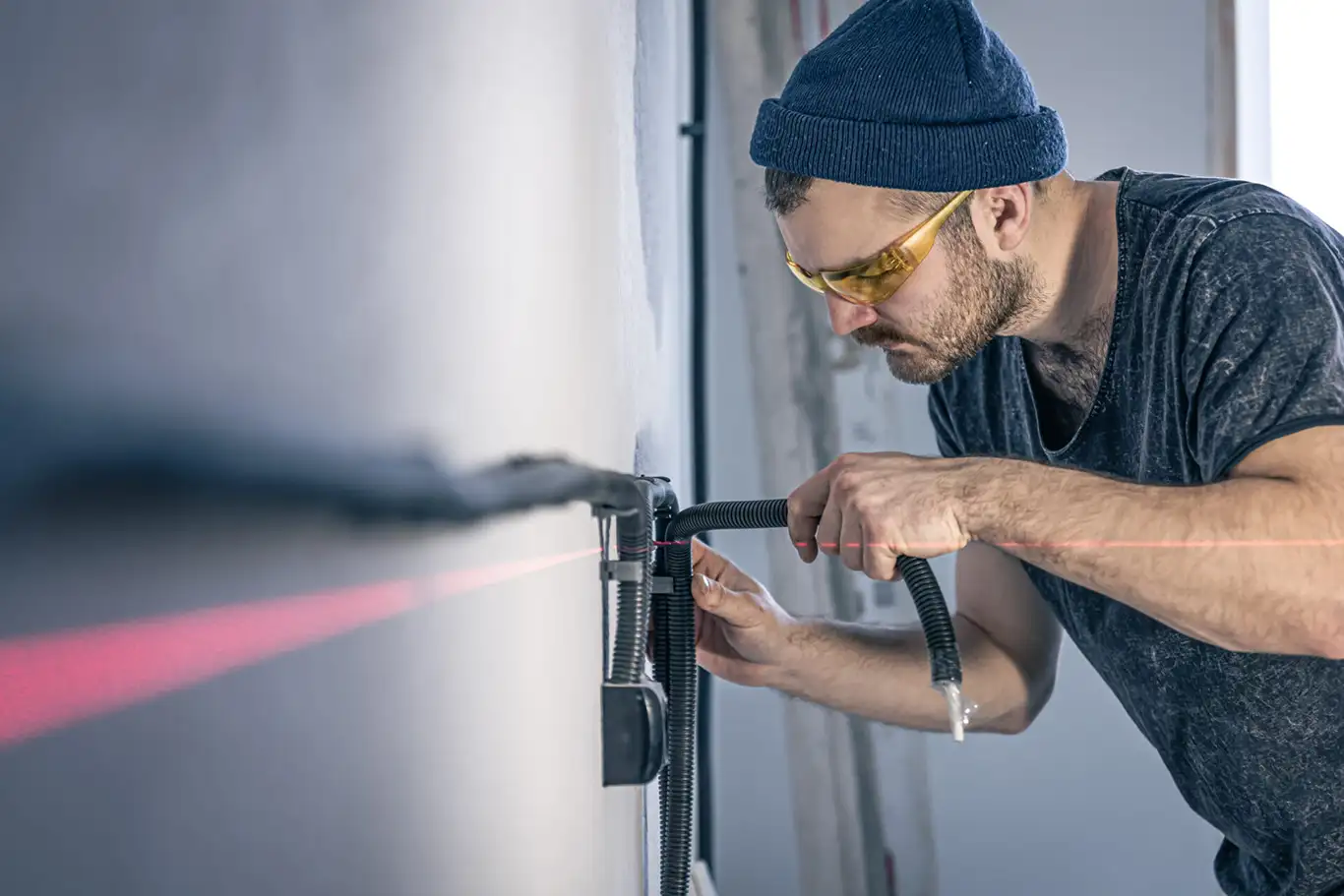 An electrician mounting electrical sockets