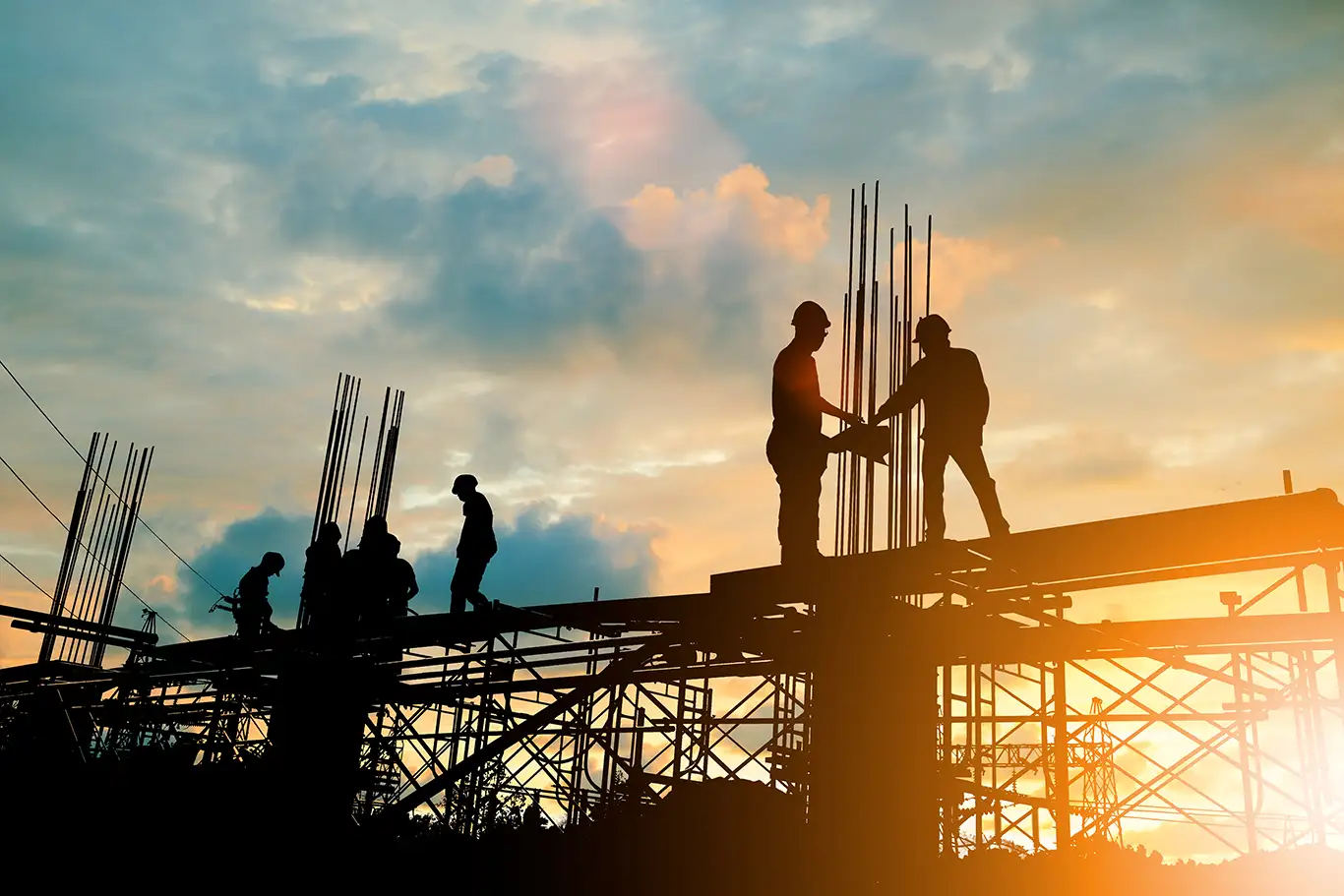 workers on a jobsite at sunset