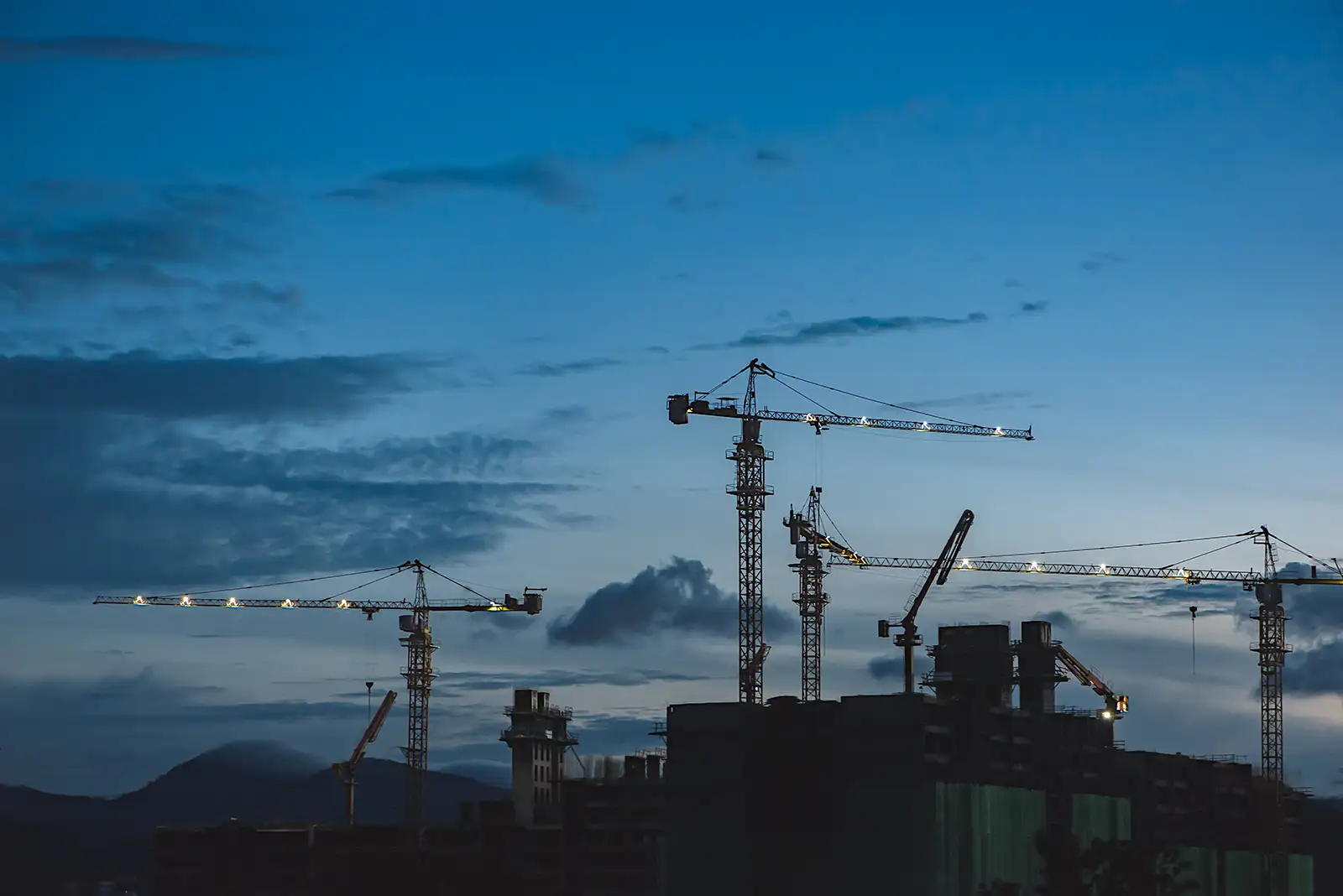construction cranes at dusk