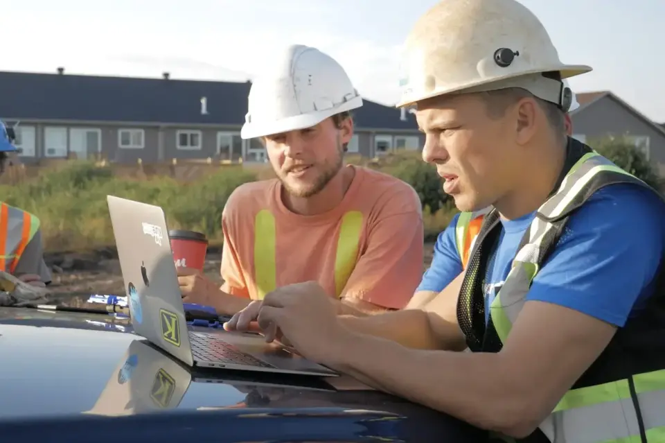 Shawn Watts on a laptop working with Corfix at the jobsite
