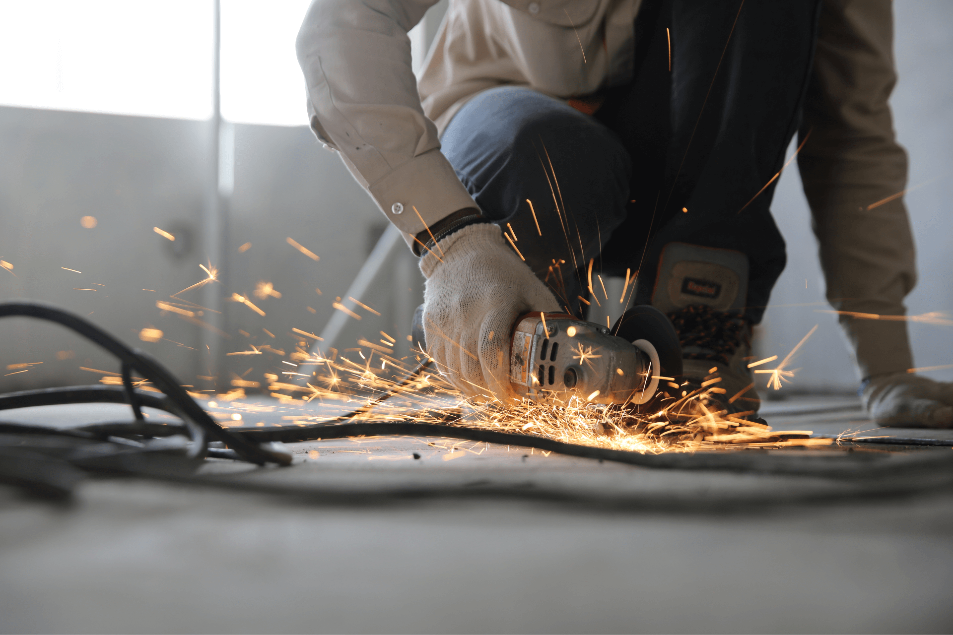 worker cutting metal and sparks are flying