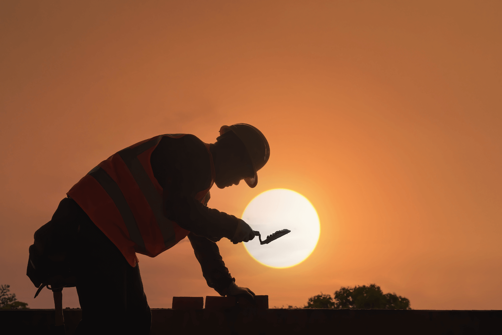 bricklayer in silhouette