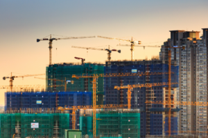 multiple cranes on a large worksite